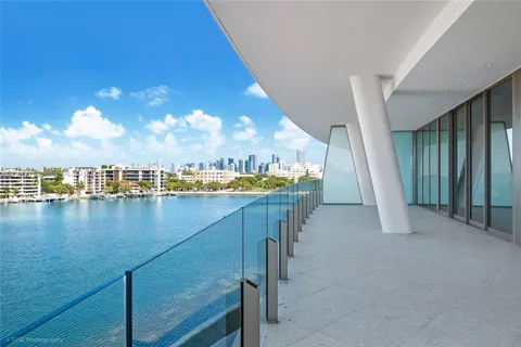 a view of a balcony with dining table & chairs