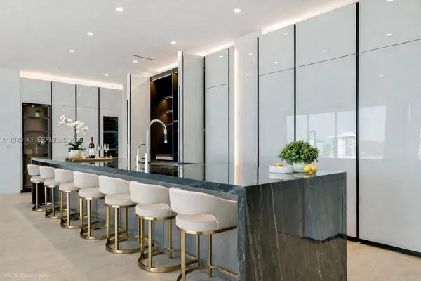 a large kitchen with lots of counter space and furniture