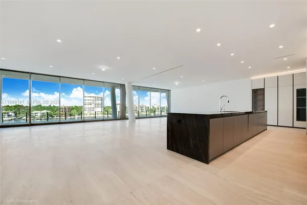 a view of kitchen with stainless steel appliances granite countertop a stove and a large window