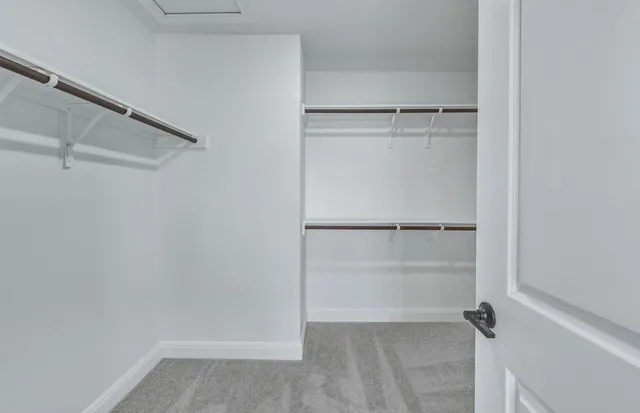 a spacious bathroom with a double vanity sink a mirror and shower