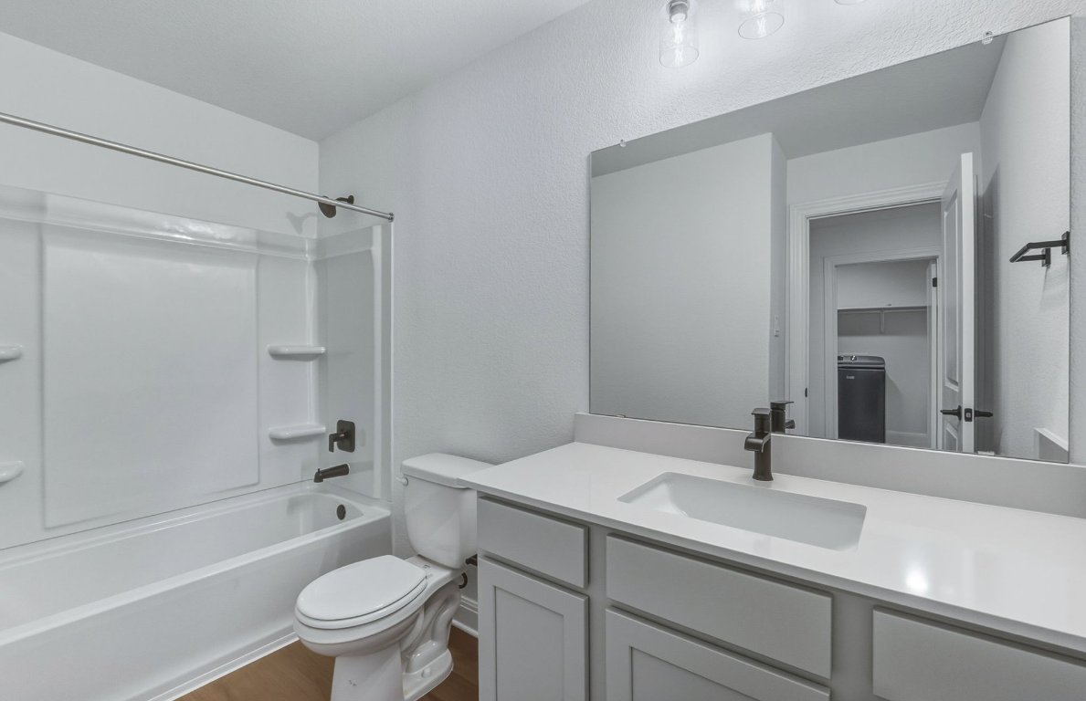 213 Regatta Trail Leander, TX 78641 - Photo 17 of 26 a bathroom with a sink toilet tub and shower