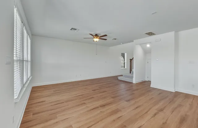 a view of kitchen with refrigerator and window