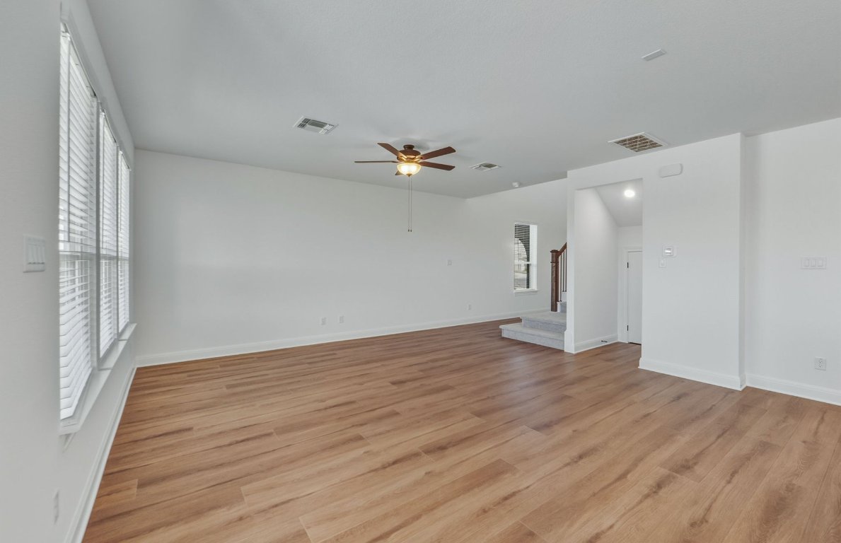 213 Regatta Trail Leander, TX 78641 - Photo 6 of 26 wooden floor in an empty room with a window