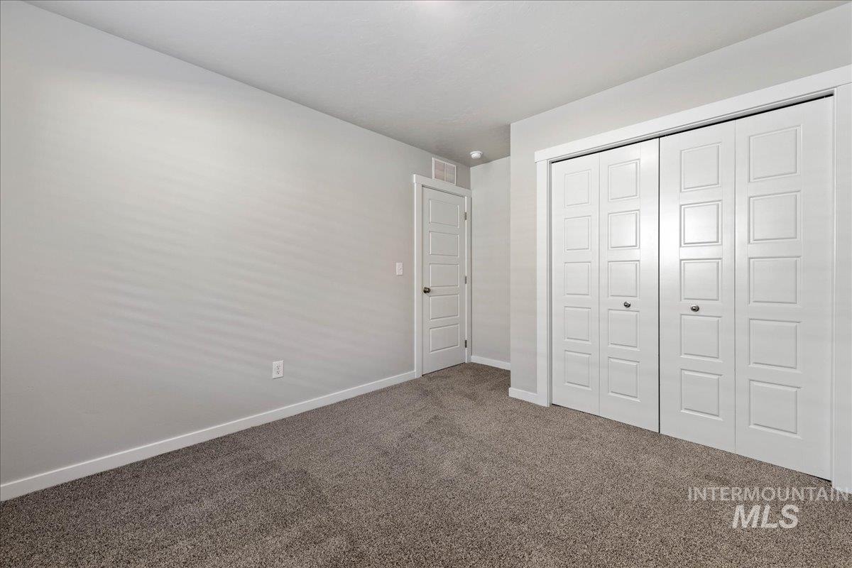 3085 S Green Boise, ID 83709 - Photo 20 of 32 Unfurnished bedroom with carpet flooring and a closet