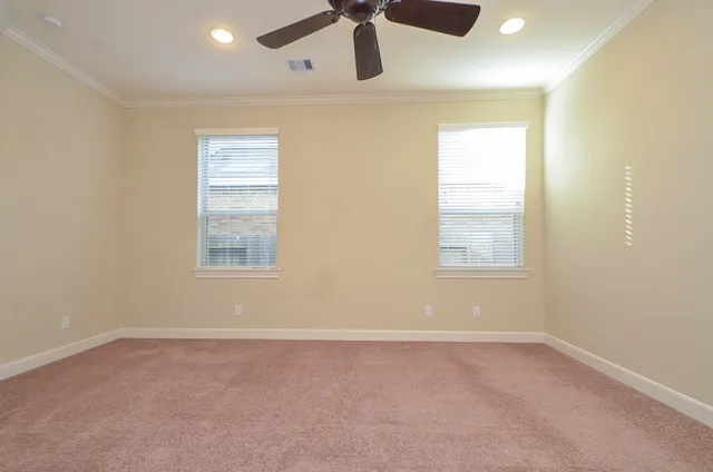 an empty room with windows and cabinet