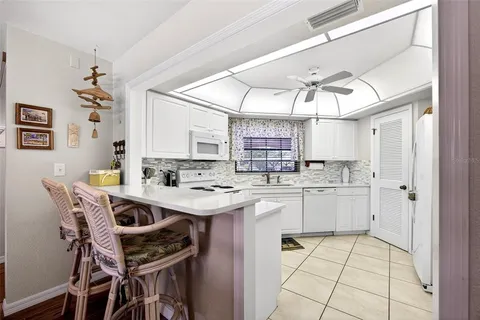 a kitchen with a sink a stove a refrigerator and cabinets