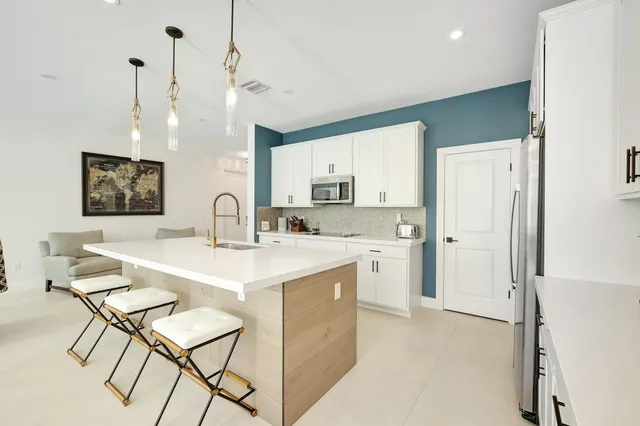 a kitchen with a sink cabinets and refrigerator