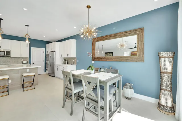 a view of a dining room with furniture and a chandelier
