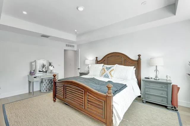 a bedroom with a bed and a lamp