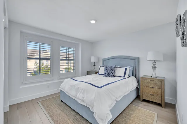 a bedroom with a large bed and a window