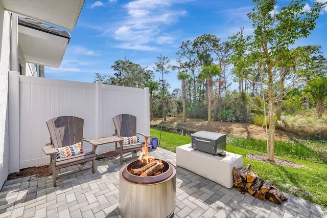 a view of a patio with a dining table and chairs