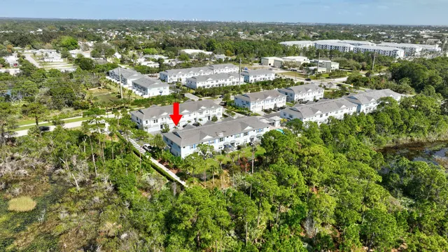 an aerial view of residential houses with city view