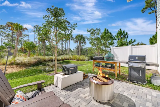 a view of a roof deck with couches and potted plants