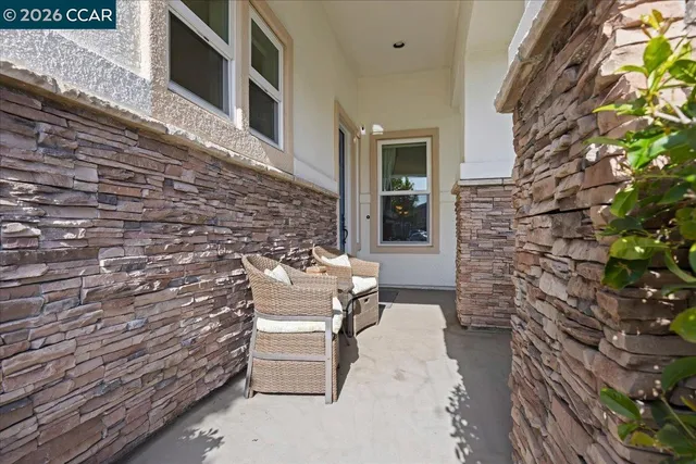 a view of a patio with table and chairs with wooden floor and fence