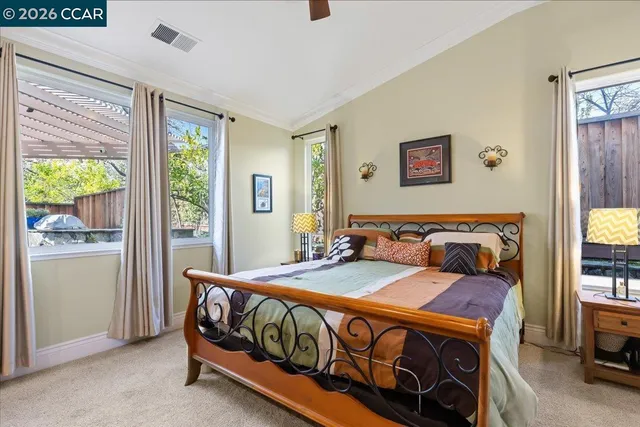 a bed sitting in a bedroom next to a window