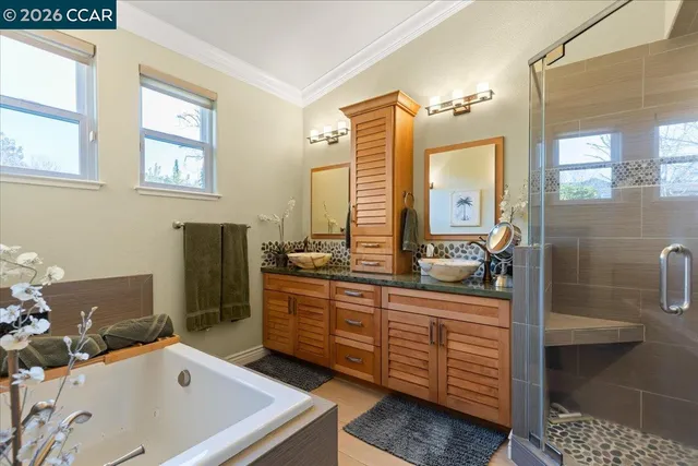 a bathroom with a tub sink and mirror