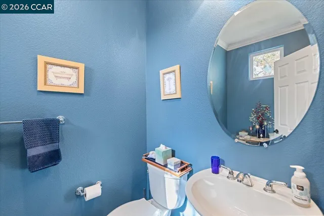 a bathroom with a toilet a sink and a mirror