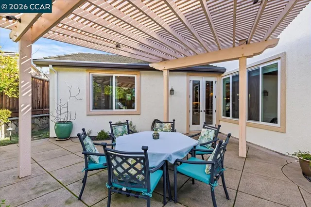 a view of a patio with table and chairs and potted plants