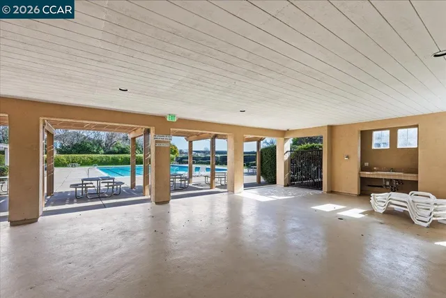 a view of a porch with furniture and floor to ceiling window