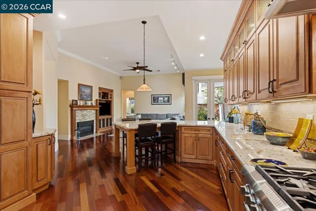 a kitchen with lots of wooden furniture appliances and cabinets