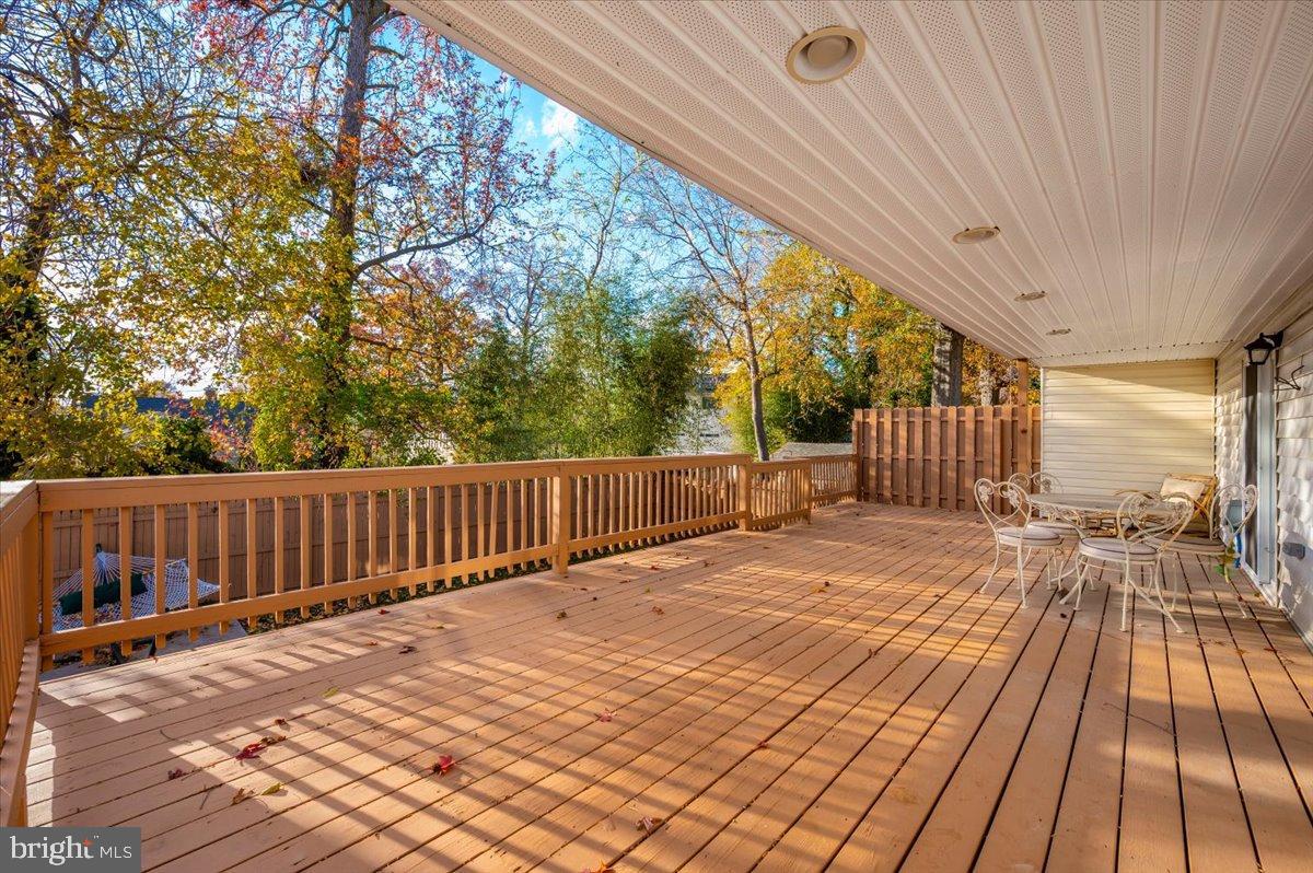 1306 3rd Road Middle River, MD 21220 - Photo 42 of 60 Sunny deck surrounded by vibrant autumn foliage.