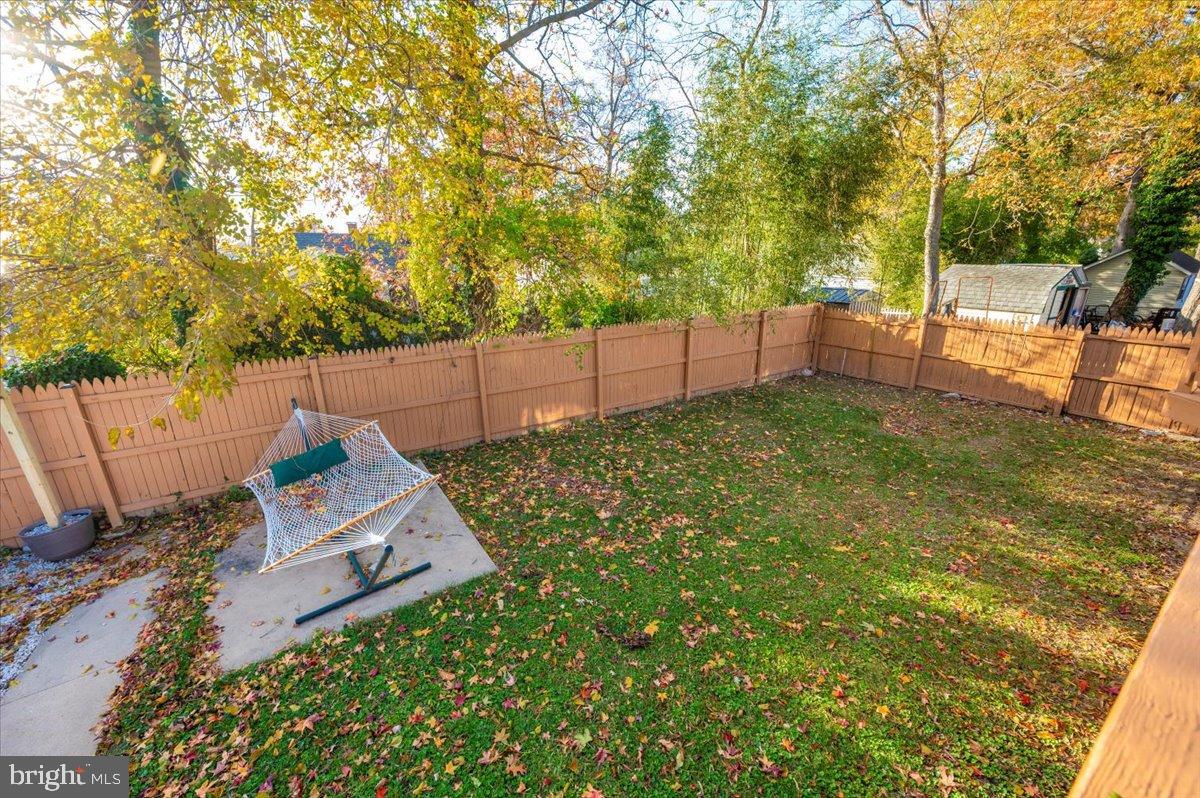 1306 3rd Road Middle River, MD 21220 - Photo 46 of 60 Serene backyard retreat with autumn hues.