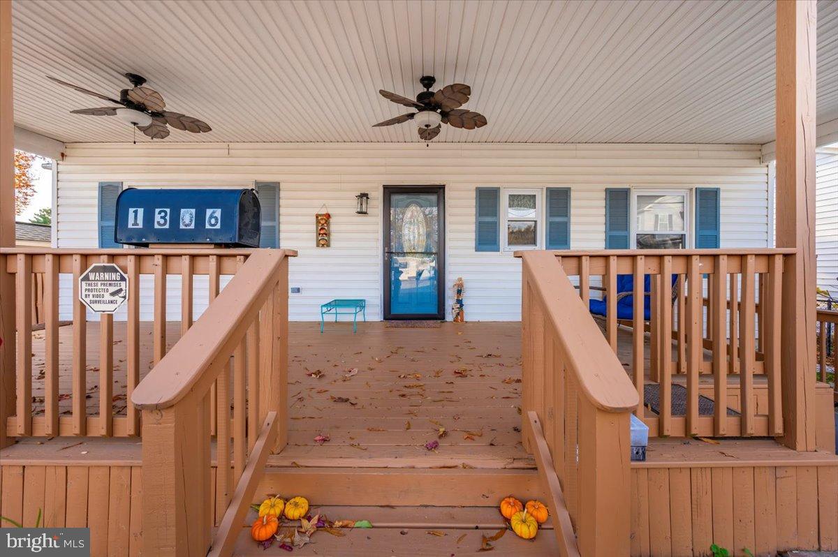 1306 3rd Road Middle River, MD 21220 - Photo 60 of 60 Charming porch with autumn leaves and fans.