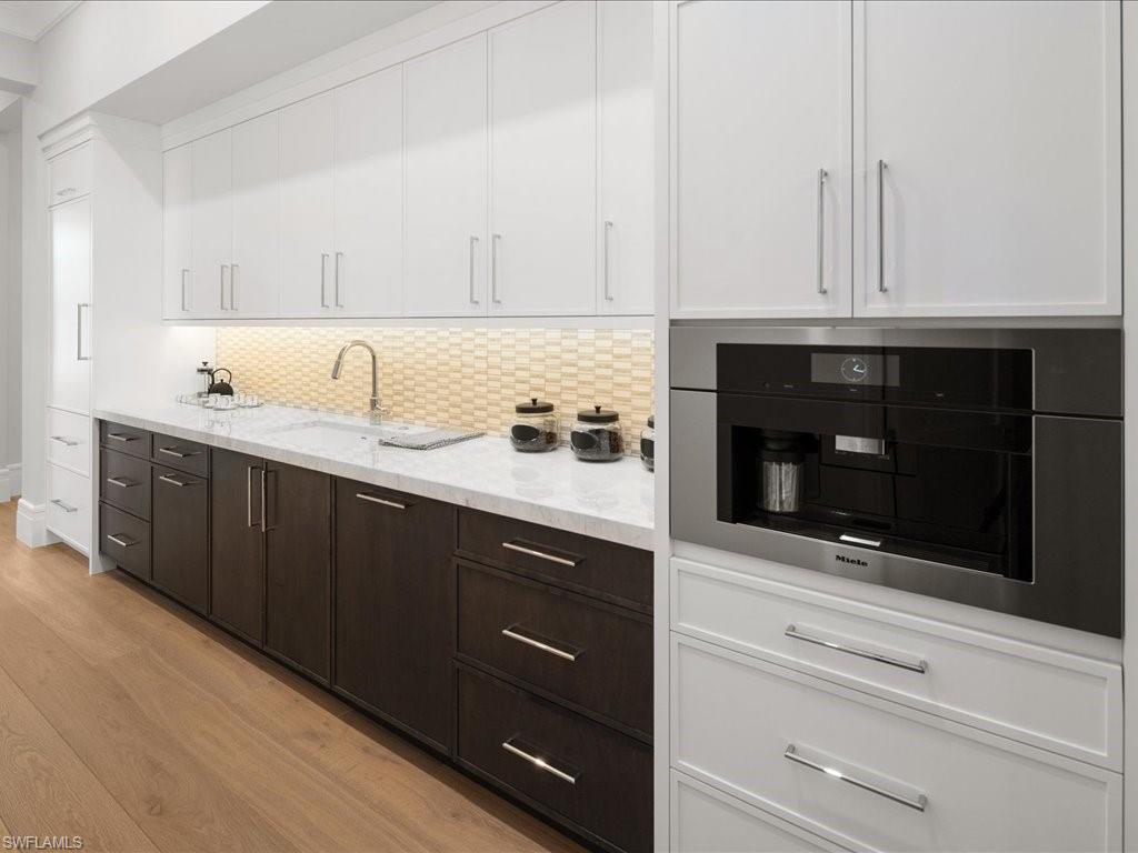 292 Bahia Point Naples, FL 34103 - Photo 11 of 50 a kitchen with a sink and cabinets