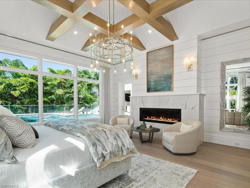 292 Bahia Point Naples, FL 34103 - Photo 15 of 50 a bedroom with a bed and a fireplace