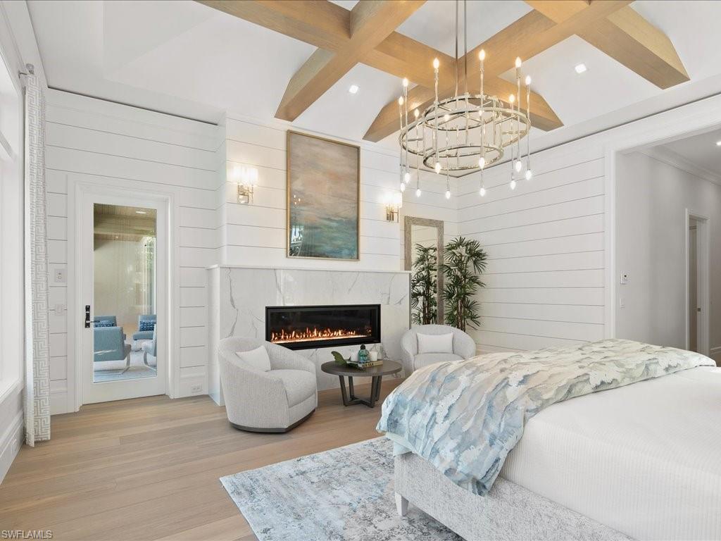 292 Bahia Point Naples, FL 34103 - Photo 16 of 50 a bedroom with a bed and a chandelier