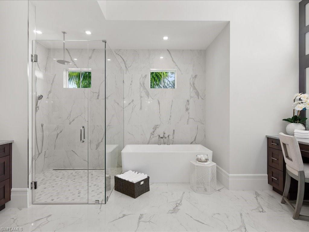 292 Bahia Point Naples, FL 34103 - Photo 17 of 50 a bathroom with a bathtub a toilet a sink and shower