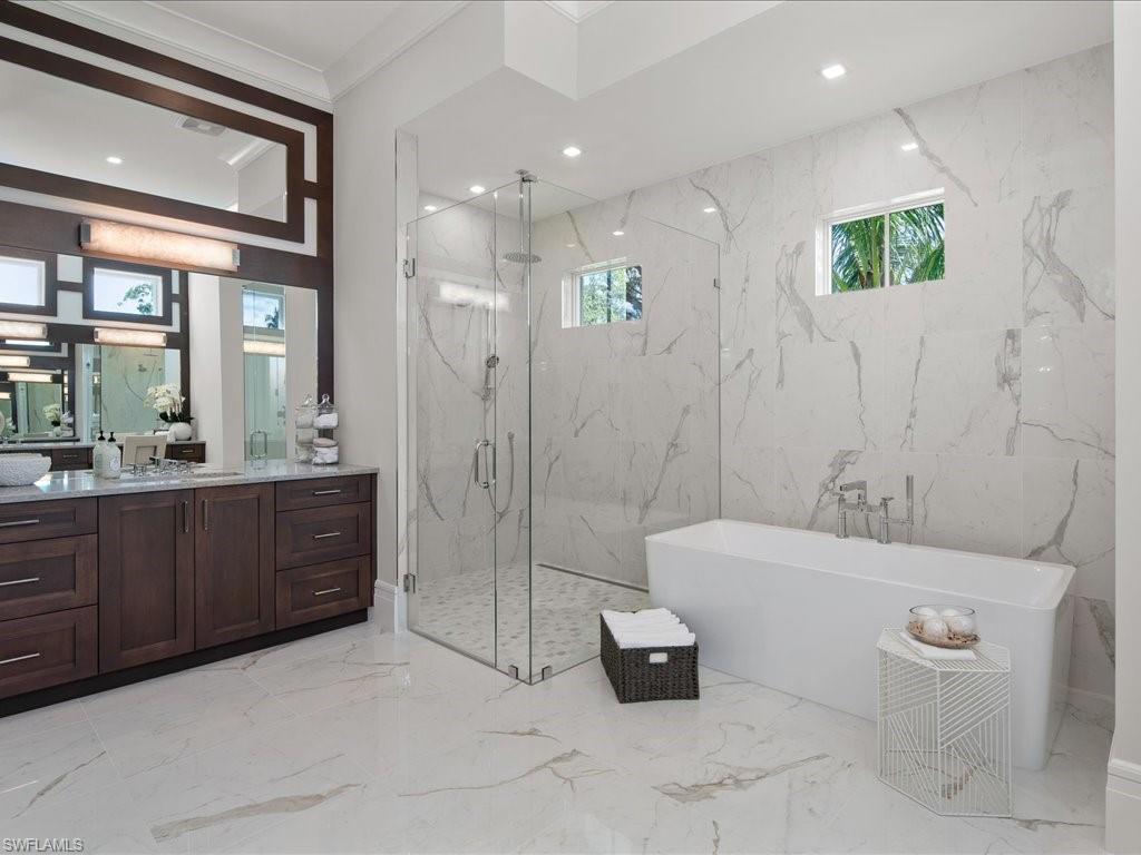 292 Bahia Point Naples, FL 34103 - Photo 19 of 50 a bathroom with a double vanity sink toilet and shower