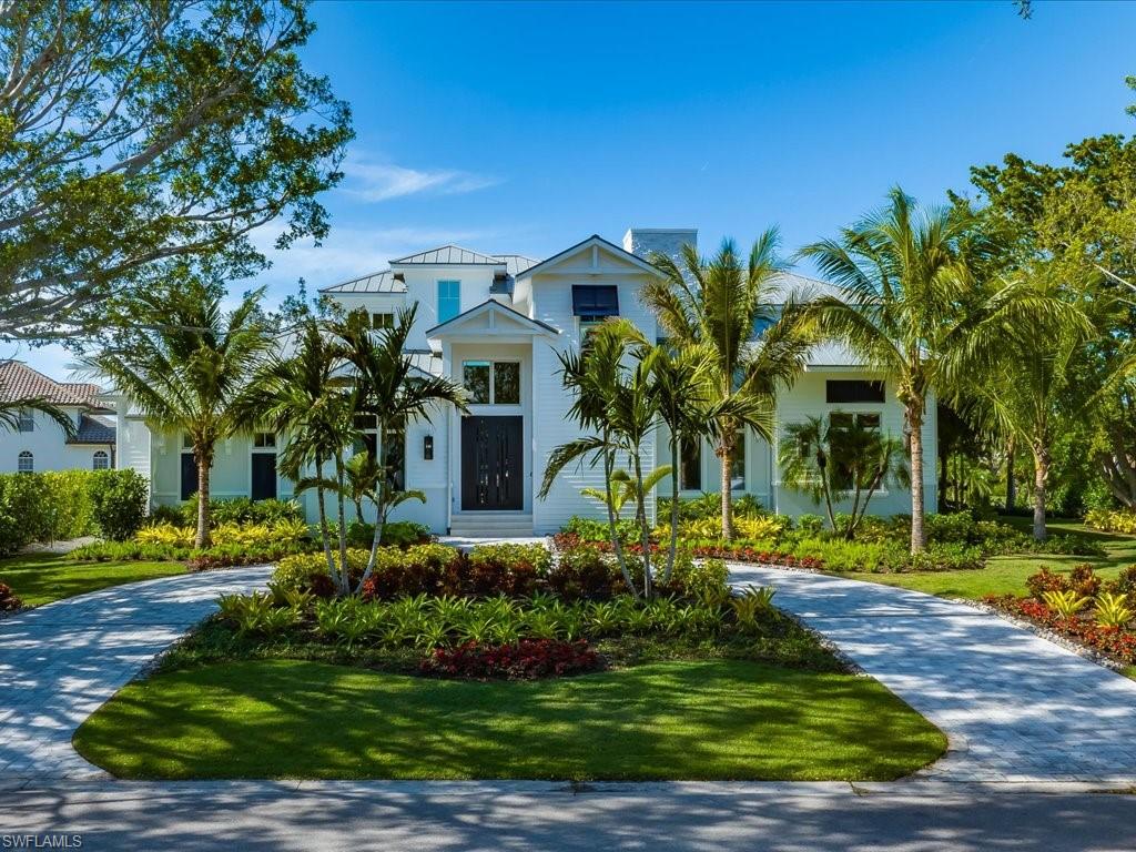 292 Bahia Point Naples, FL 34103 - Photo 2 of 50 a front view of a house with garden