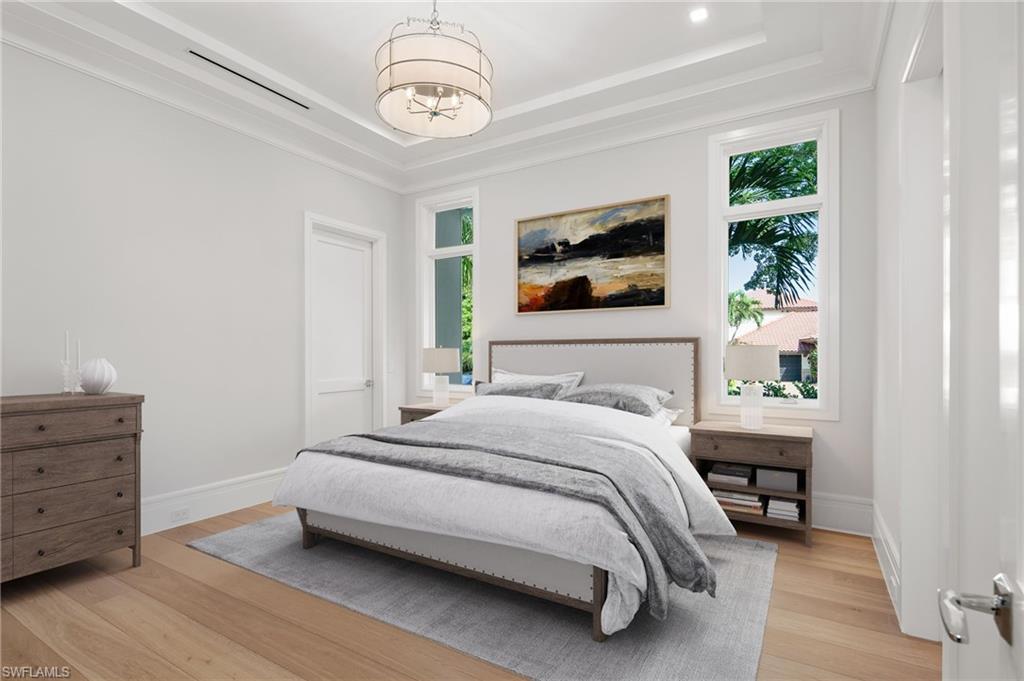 292 Bahia Point Naples, FL 34103 - Photo 22 of 50 a bedroom with a bed and a chandelier