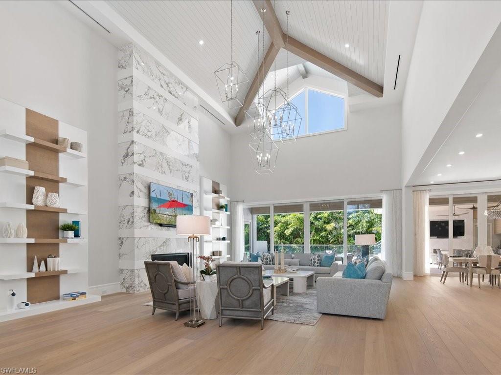 292 Bahia Point Naples, FL 34103 - Photo 3 of 50 a living room with fireplace furniture and a large window