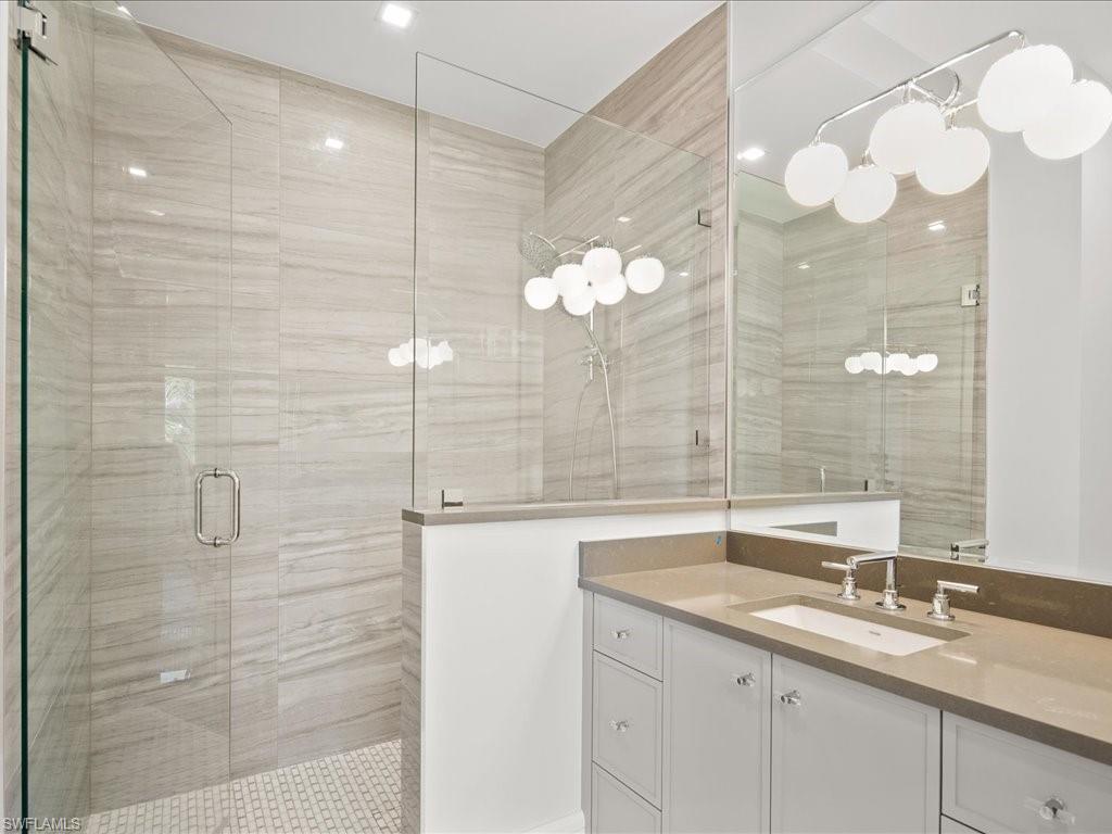 292 Bahia Point Naples, FL 34103 - Photo 34 of 50 a bathroom with a sink and a mirror