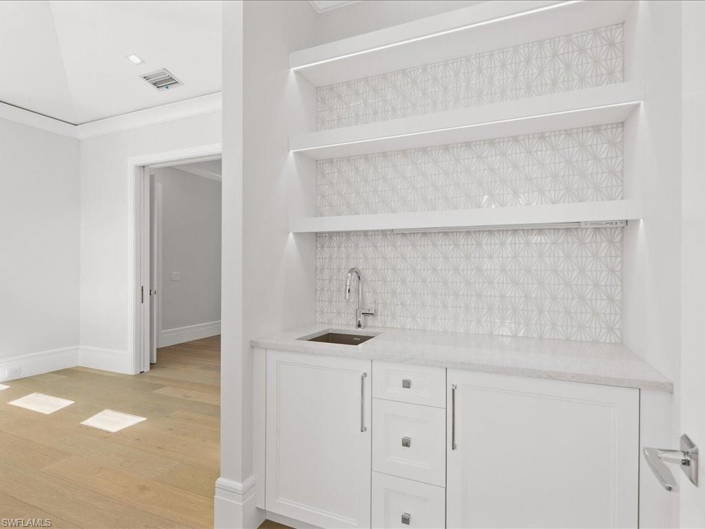 292 Bahia Point Naples, FL 34103 - Photo 35 of 50 a kitchen with a sink and cabinets