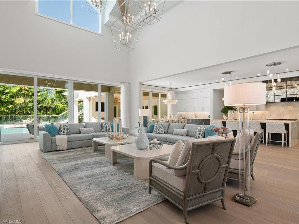 292 Bahia Point Naples, FL 34103 - Photo 4 of 50 a living room with furniture and a chandelier
