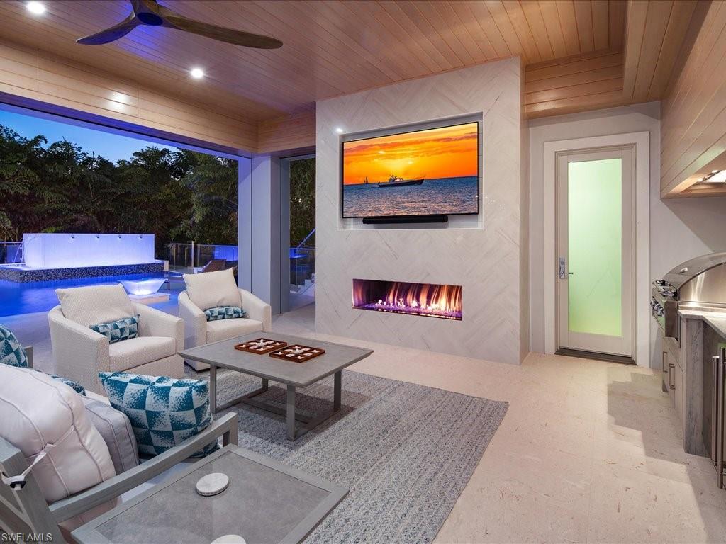 292 Bahia Point Naples, FL 34103 - Photo 43 of 50 a living room with furniture and a flat screen tv