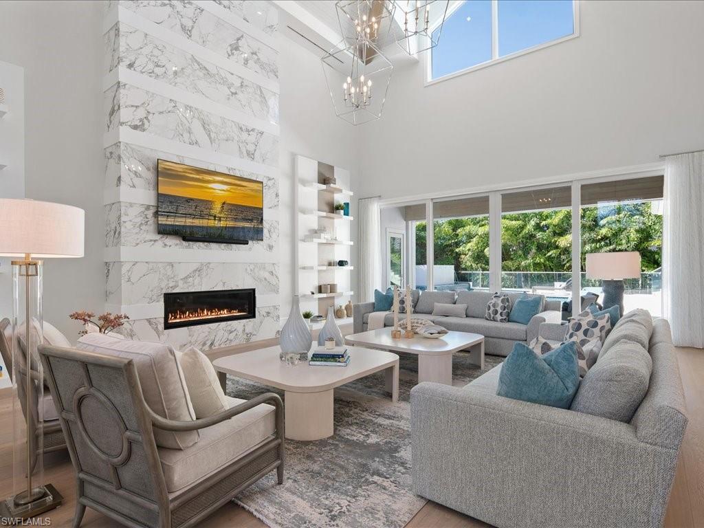 292 Bahia Point Naples, FL 34103 - Photo 5 of 50 a living room with fireplace furniture and a flat screen tv