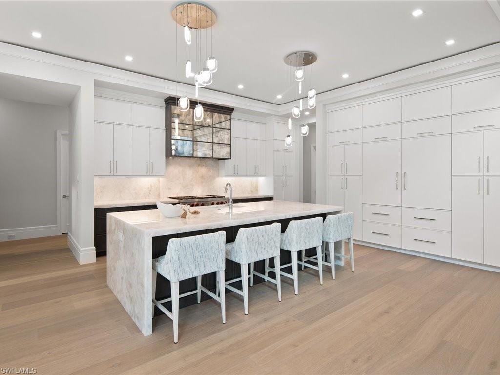 292 Bahia Point Naples, FL 34103 - Photo 9 of 50 a dining table with chairs and wooden floor