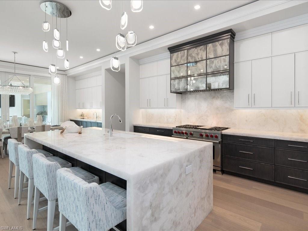 292 Bahia Point Naples, FL 34103 - Photo 10 of 50 a kitchen with stainless steel appliances granite countertop a sink a stove and a refrigerator