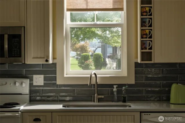 a view of a livingroom with furniture a flat screen tv and entryway