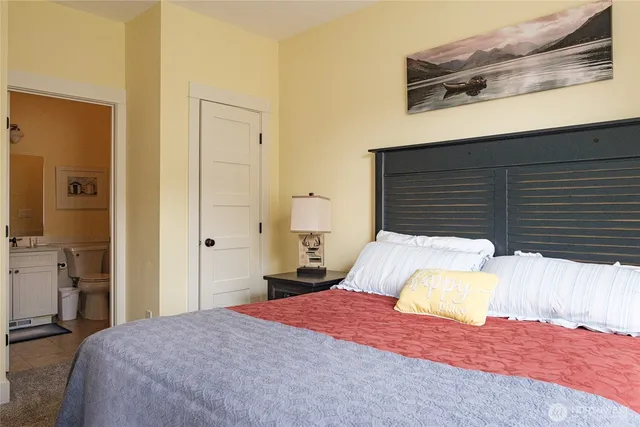 a bathroom with a toilet sink vanity and shower