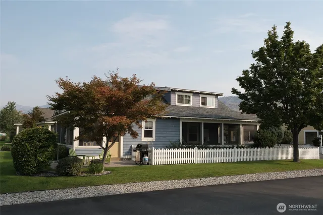 a view of a chair and table in backyard of the house