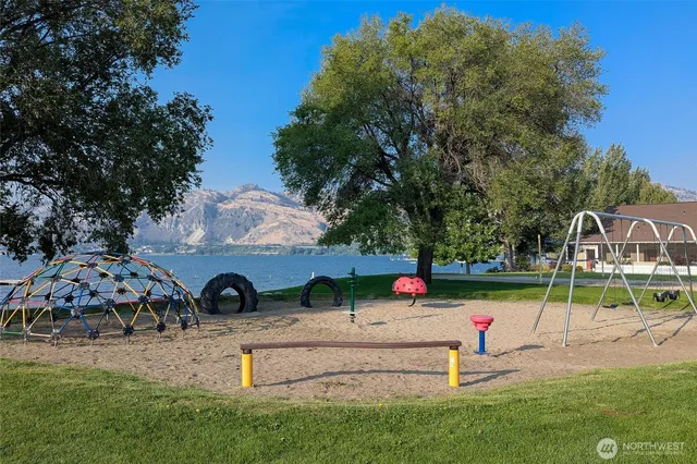 a view of a balcony with wooden floor and a floor to ceiling window