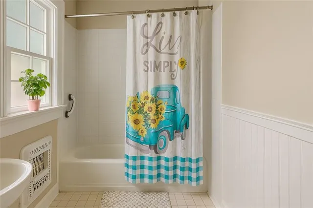a bath room with a bathtub and a shower