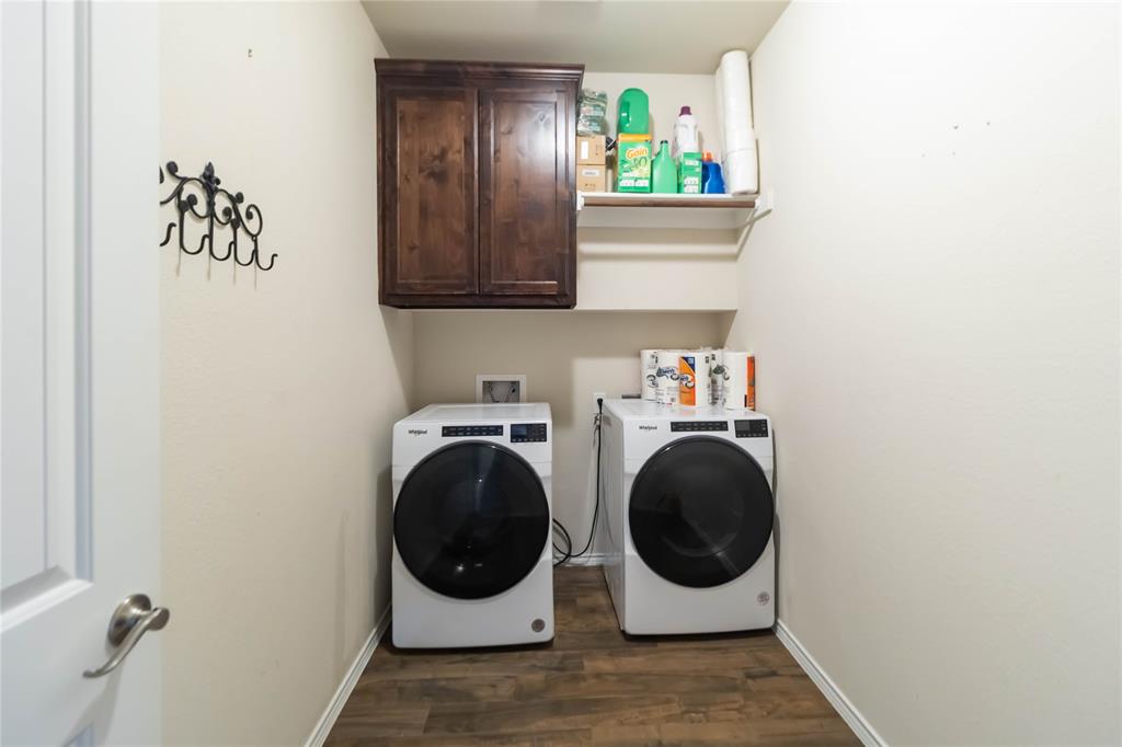 1663 Fraser Drive Burleson, TX 76028 - Photo 11 of 22 Laundry area featuring dark wood-style floors, cabinet space, and washing machine and clothes dryer