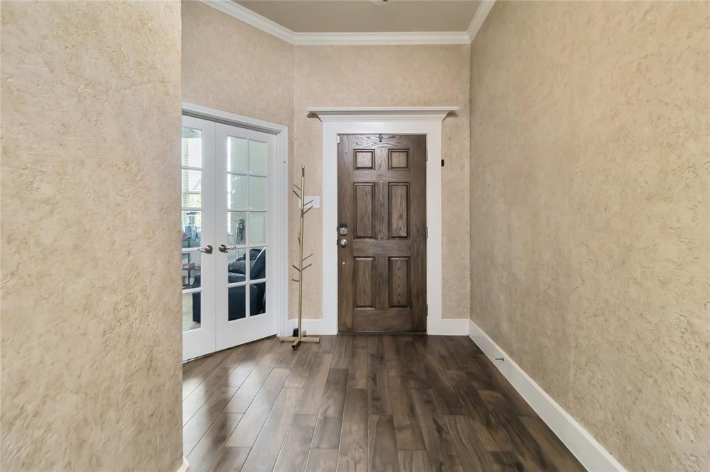 1663 Fraser Drive Burleson, TX 76028 - Photo 2 of 22 Entryway with french doors, wood finished floors, ornamental molding, and a textured wall