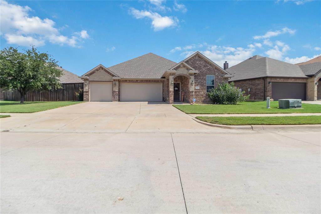 1663 Fraser Drive Burleson, TX 76028 - Photo 22 of 22 View of front of property with a garage, driveway, roof with shingles, brick siding, and stone siding